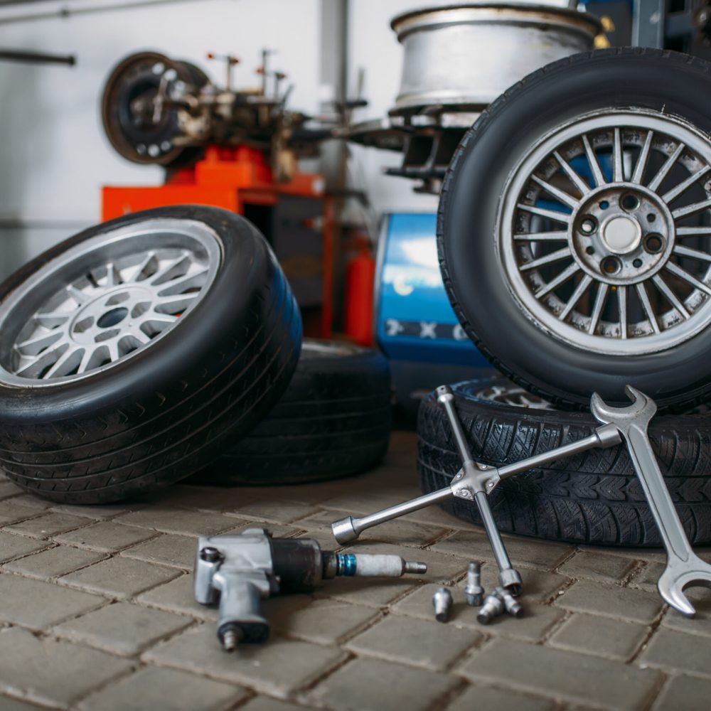 Car wheels, tire fitting machine, pneumatic wrench, repair service, nobody. Automobile tyre repairing tools and equipment, vehicle inspection in workshop
